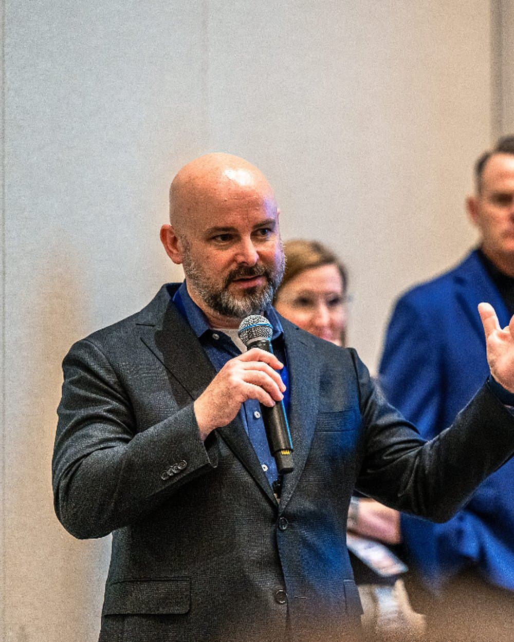 Hunter Samuels speaking to a room with a microphone in hand.